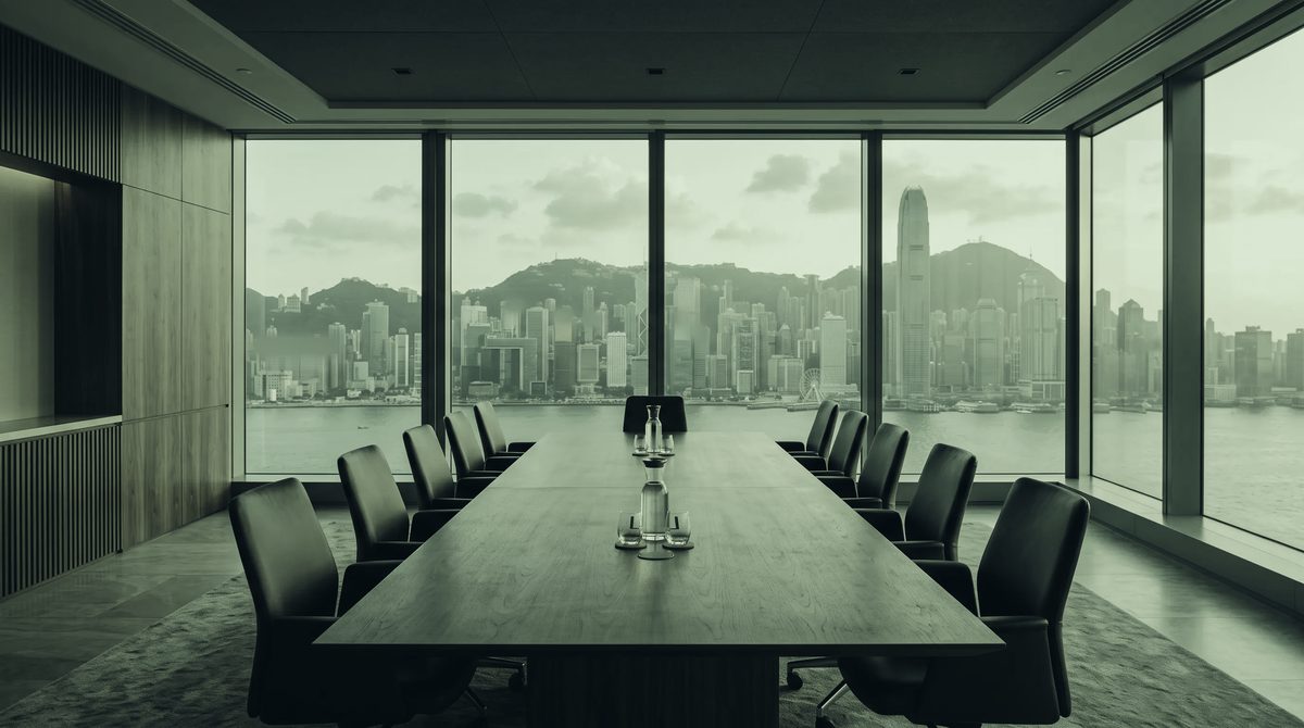 An empty boardroom at dusk, the city beyond the glass